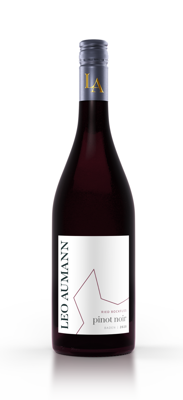 A bottle of Leo Aumann Pinot Noir with a white label and gold-colored cap on a white surface.